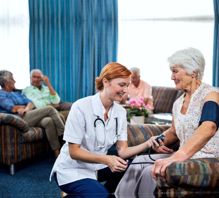 nurse checking the vital signs of an elder woman